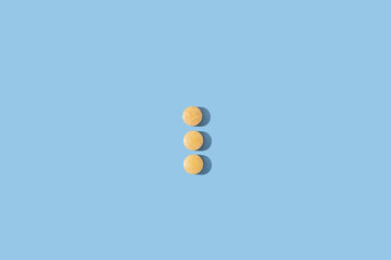 Medical pills on blue background. 
Nutritional supplements and vitamins concept