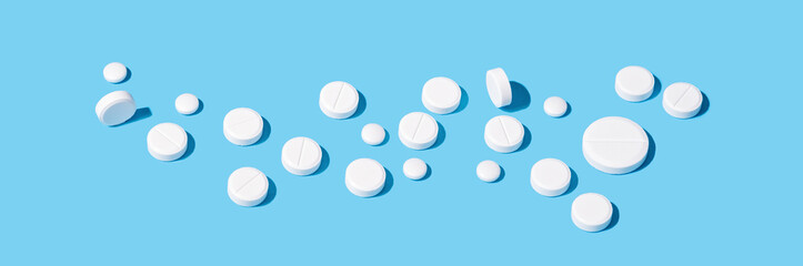 Medical pills on blue background