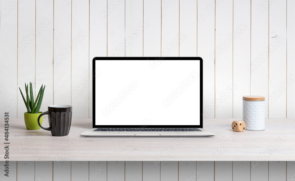 Aufkleber lapop on desk with isolated white screen for mockup, app or web page design promotion. white wooden 