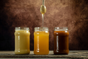 Macro photo of a bee hive on a honeycomb. Bees produce fresh, healthy, honey. Honey background. Beekeeping concept. Long banner format