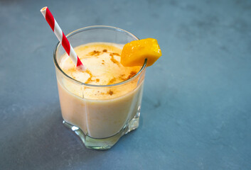 Yellow Indian mango yoghurt drink Mango Lassi or smoothie with turmeric and saffron.