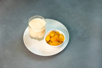 Yellow Indian mango yoghurt drink Mango Lassi or smoothie with turmeric and saffron.