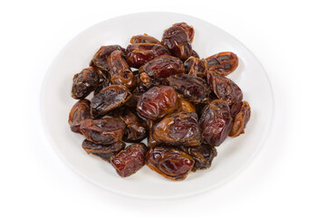 Heap of dried date fruits on a white plate