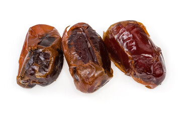 Three dried date fruits on a white background close-up