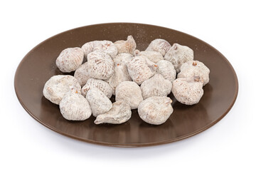 Dried figs on the brown dish on a white background