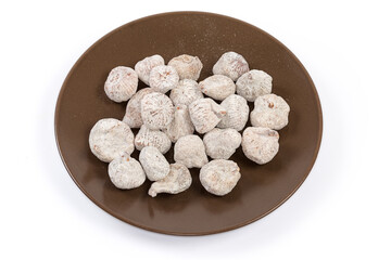 Dried figs on the brown dish on a white background