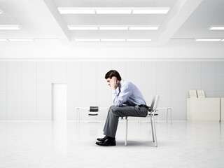Fototapeta premium young businessman on chair in office