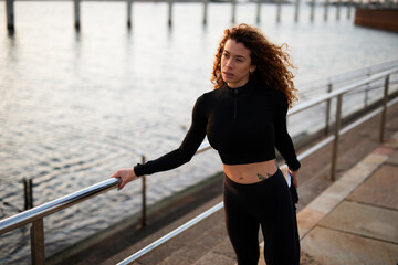Beautiful young woman training outside. Fit sexy woman doing exercise.