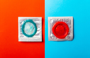 condoms in a red-blue background. The concept of safe sex, prevention of venereal diseases