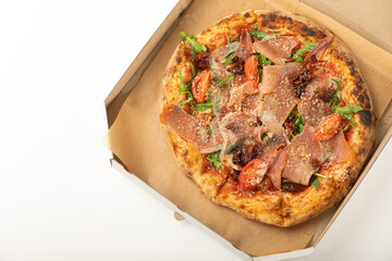 Banner
close-up of Delicious pizza in a box on a white background. Top view of hot pizza. With copy space for text.