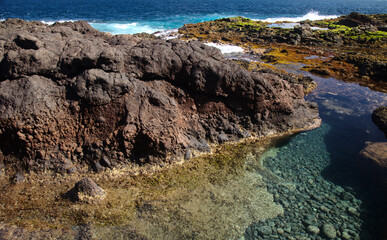 Gran Canaria, calm rock pools under steep cliffs of the north coast are 
separated from the ocean by volcanic rocks of platform constructed by old lava flows
Punta de Galdar area