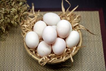 Close-up white eggs in wicker basket