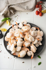 Thawed peeled shrimp, seafood, delicacy. on a white background, in a dish. beautiful product presentation