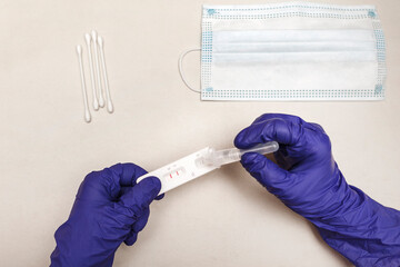 Covid-19 testing. Hands in medical gloves making covid rapid swab test. Antigen quick corona test....