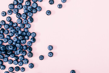 Berry background. Fresh berry blueberries on a pink background. Concept of healthy and dieting eating. Flat lay, top view, copy space