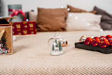 Light bedroom with Christmas decorations, toys and gifts. Winter cozy style
