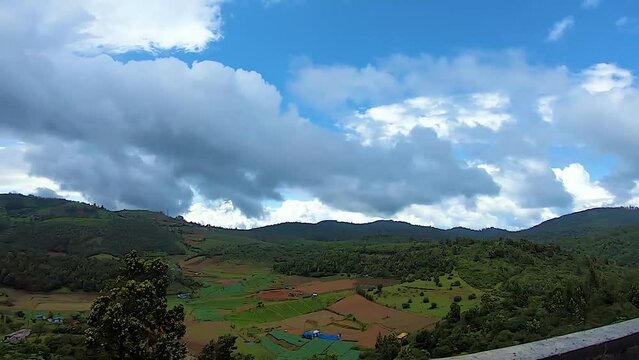 countryside farming field with mountain and bright blue sky background