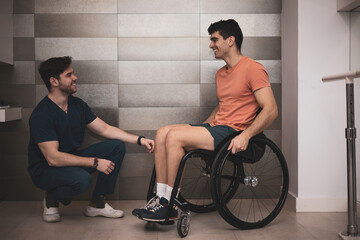 a young man in a wheelchair visits an orthopedist for rehabilitation.concept of overcoming and effort.