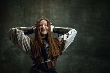 Young medieval warrior or knight with dirty wounded face in headphones listening to music isolated...
