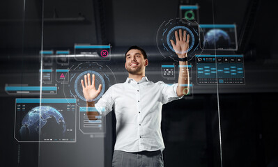 business, augmented reality and technology concept - happy smiling businessman working and touching glass screen with virtual projection at night office