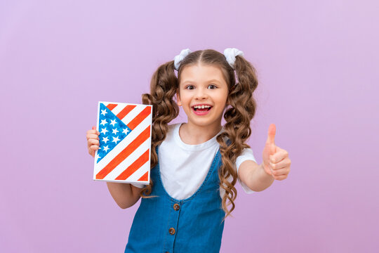 A girl with a textbook with the image of the US flag, a child likes studying abroad, Living abroad and receiving a certificate of graduation.