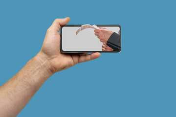 Male hand holding mobile phone with app for sending and receiving payment checks