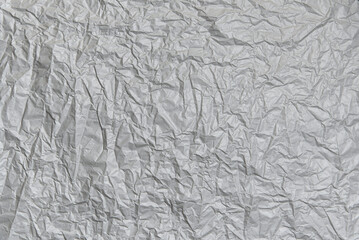 Crumpled gray paper texture. Abstract blank grey background for design.