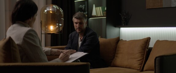 40s Caucasian male having an appointment with his psychologist in the evening