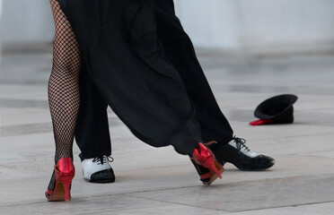 Fragment photo of tango dancers. Only legs, tango dancers. Milonga. Man and woman dancing tango,...