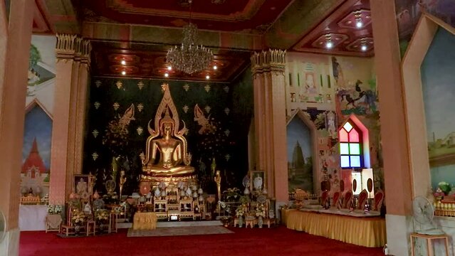 golden buddha statue at monastery from flat angle