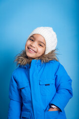 portrait of young Asian girl with big smile showing her teeth and with her hand in pockets of her jacket