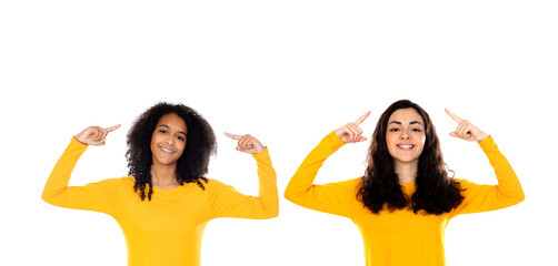 Two teenager girls pointing at their heads