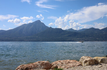 Torri del Benaco, Italy, Lake Garda, August 2021 View of the lake and the mountain formation from the east side to the west side of the lake in beautiful weather with blue sky