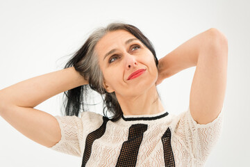 Studio photo of middle aged woman starting getting grey-haired wearing black and white clothes on white background, middle age sexy lady, happy life concept