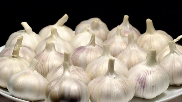 Fresh garlic bulbs rotation background. Loop motion