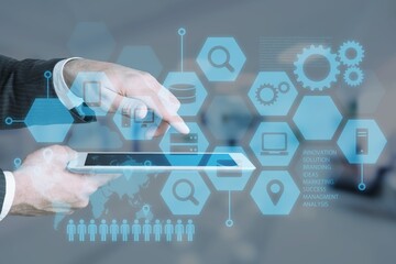Businessman with digital tablet working with business infographics interface and digital graphs