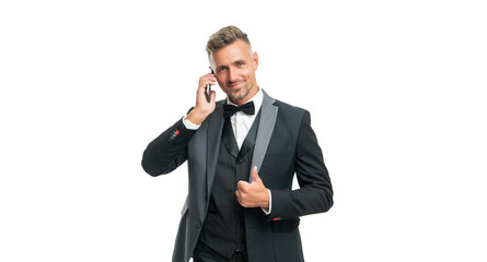 Naklejka premium cheerful gentleman in tuxedo speak on phone isolated on white background. thumb up