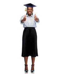 education, graduation and people concept - happy graduate student woman or bachelor in mortarboard showing thumbs up over white background