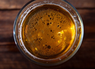 Glass of light beer top view closeup