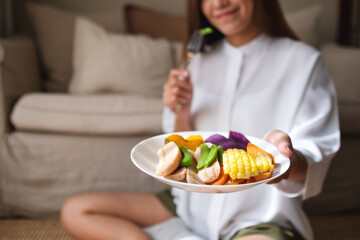 Closeup image of a young woman eating vegetables, Vegan, clean food, dieting concept
