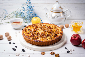 pie with apples, nuts and raisins on a white background