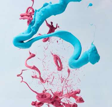 Explosion Of Blue And Pink Paint Over Gray Background