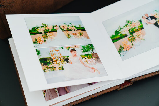 wedding photobook with photos of the newlyweds on a black background