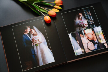 wedding photobook with photos of the newlyweds on a black background