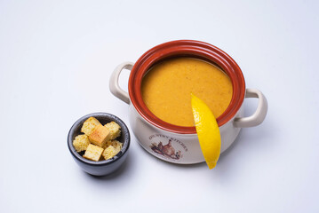 pumpkin soup with crackers. on a white background