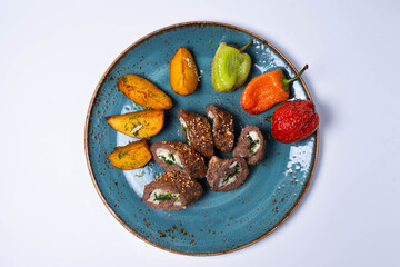 meatloaf with fried potatoes and vegetables. on a white background