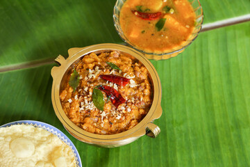 Traditional South Indian pumpkin curry dish in Kerala, India , Sri Lanka, coconut oil, Indian spices for cooking. vegetarian side dish of rice coconut rice Onam sadhya, Vishu, Pongal.