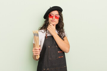 young pretty hispanic woman thinking, feeling doubtful and confused. artist concept