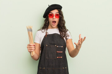 young pretty hispanic woman feeling extremely shocked and surprised. artist concept