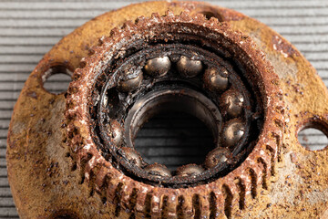 Old rusty wheel hub with a broken bearing. Bearing jamming. Automotive Part, close-up.